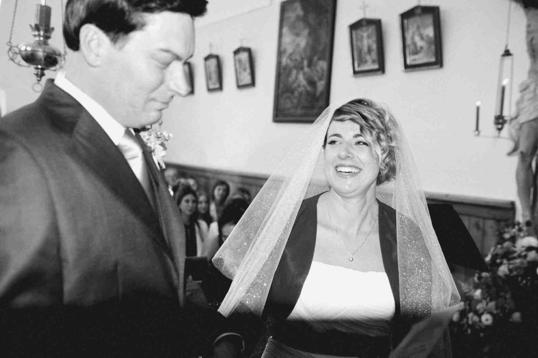Sposi sorridenti durante lo scambio delle fedi ad Arabba, servizio del fotografo matrimonio Cortina d'Ampezzo.