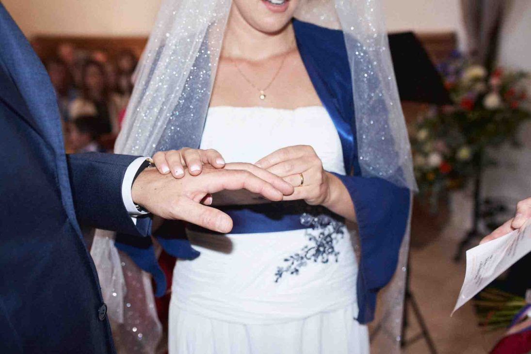 Dettaglio mani sposi scambio anelli ad Arabba, servizio fotografo matrimonio Arabba - dolomiti.